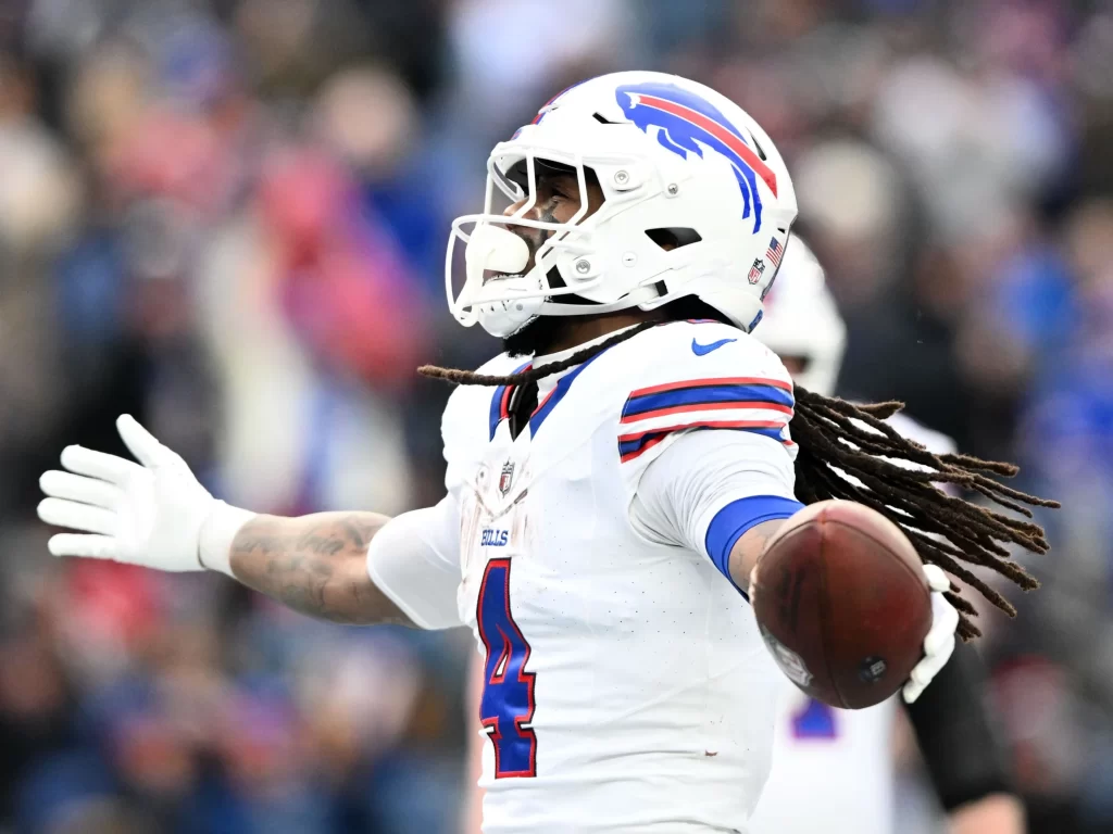 James Cook celebrates in his all white Bills uniform.